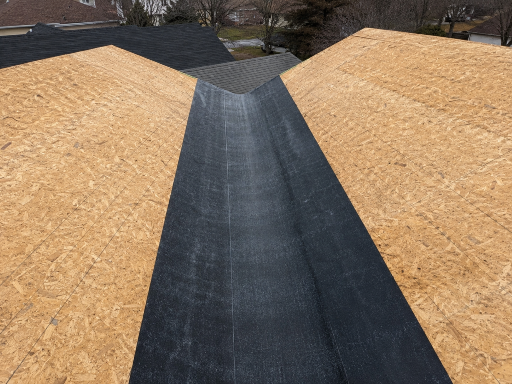 Ice and water shield membrane installed down a roof valley before shingles